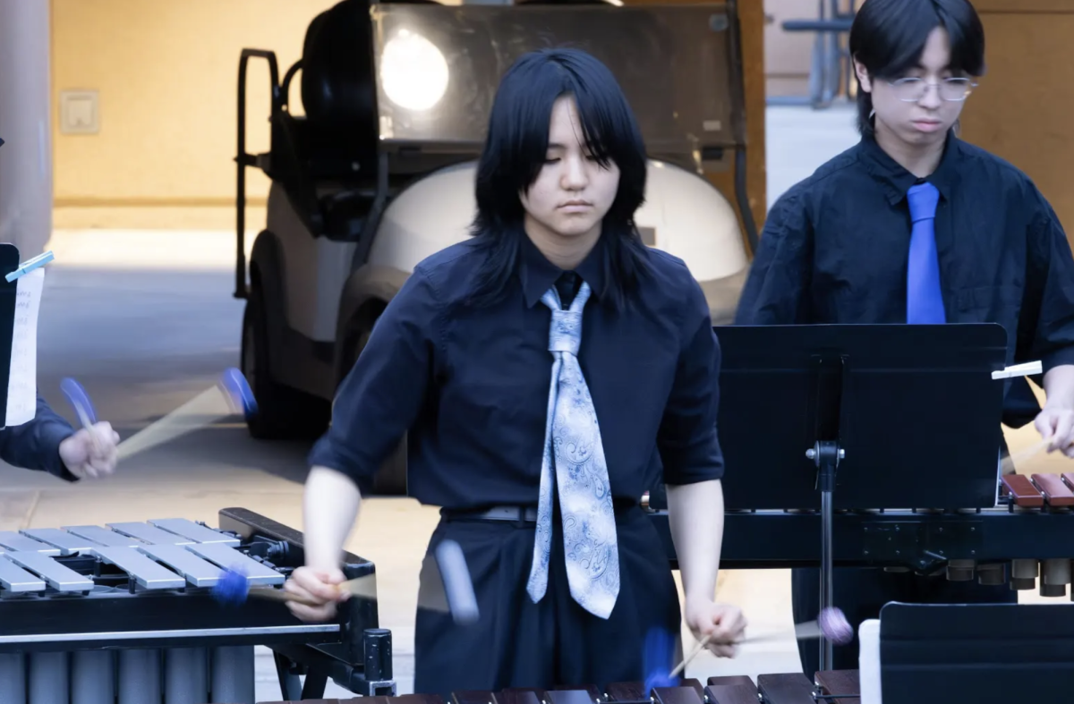 PLAYING PERCUSSION: junior Yun Wen strikes the bars with four mallets during percussion ensemble’s performance at Jazz at the Oak.